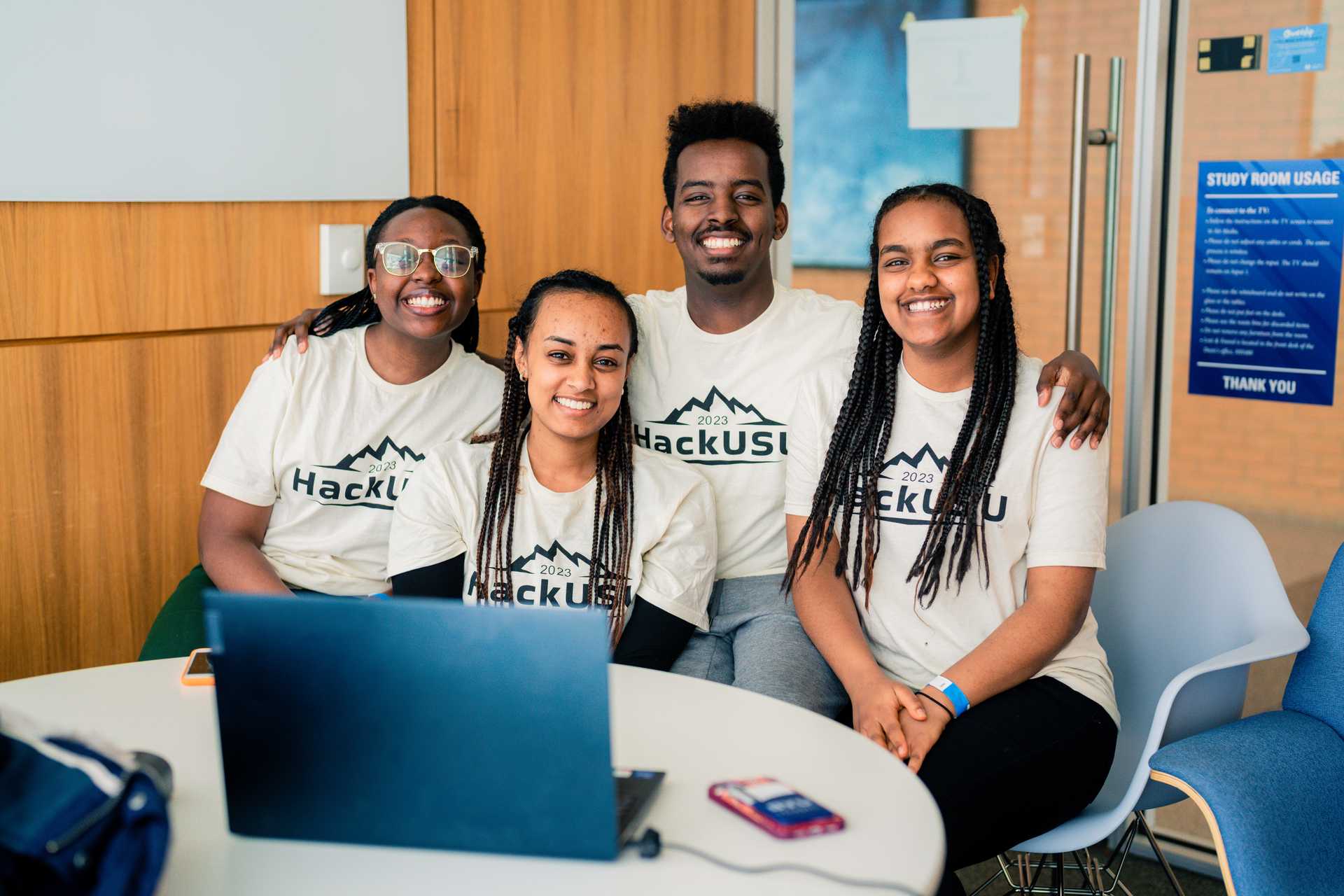 A group of students wearing HackUSU shirts